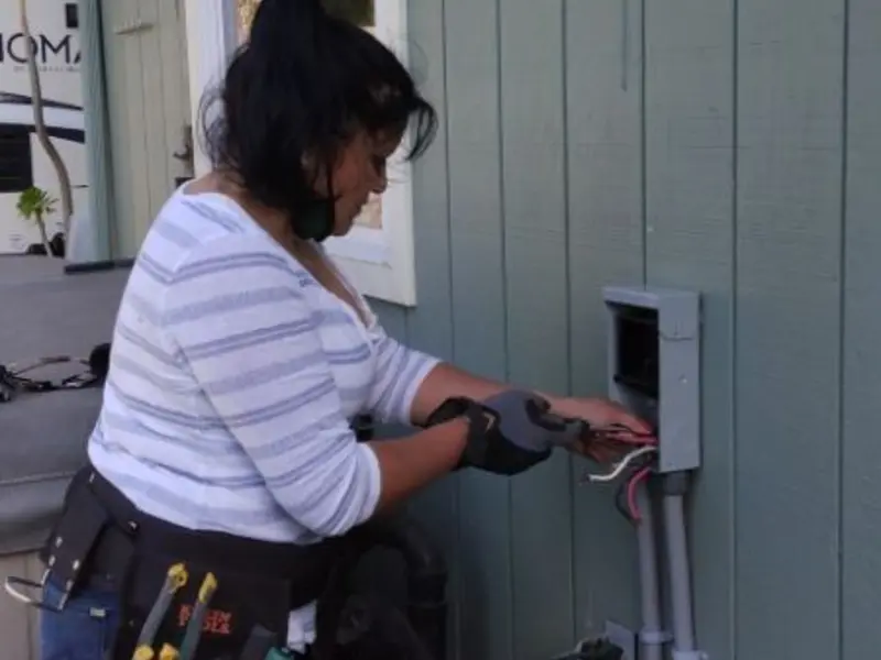 Licensed electrician wiring an exterior subpanel in Andover